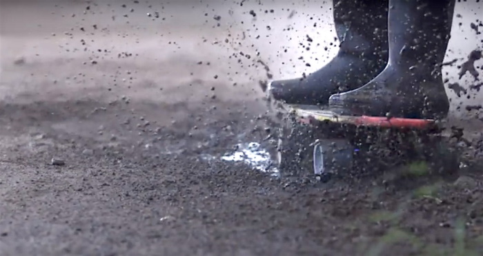 Riding a skateboard in the mud